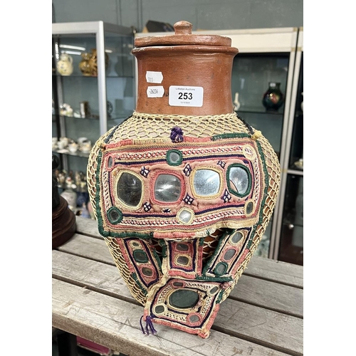 253 - Lidded terracotta pot with cane wrap together with a Jordanian woman's mask