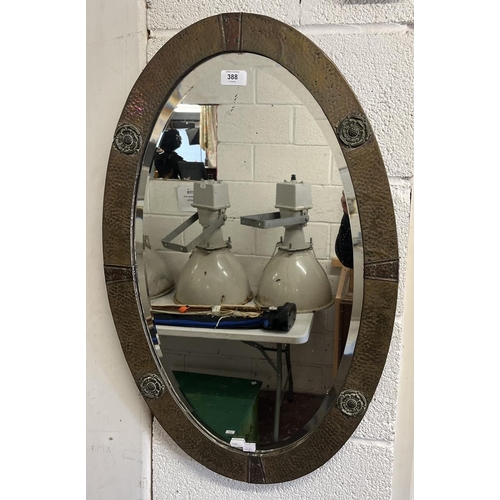 388 - Arts & Crafts brass and copper planished mirror with Tudor rose decoration and original beveled ... 