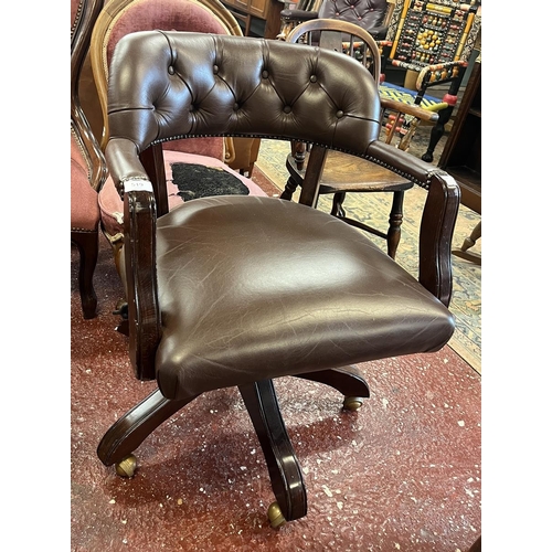 519 - Leather swivel armchair