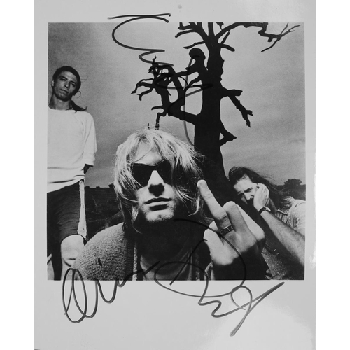 141 - 10x8 B&W promotional photograph of Nirvana.  Signed in blue ink by all three band members (typic... 