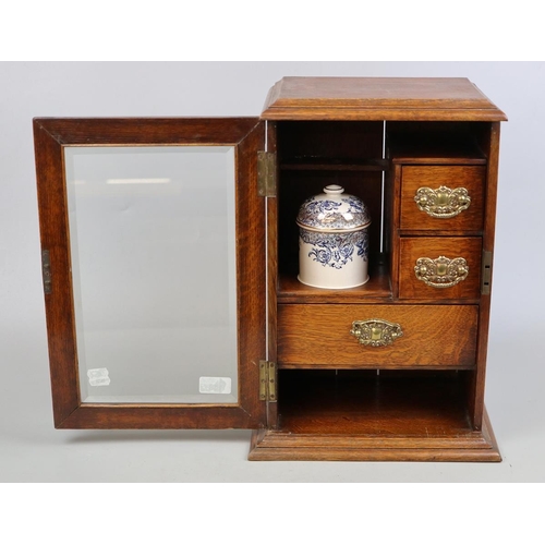 150 - Edwardian oak bevel glazed smokers cabinet with gilded, blue and white porcelain humidor and white m... 