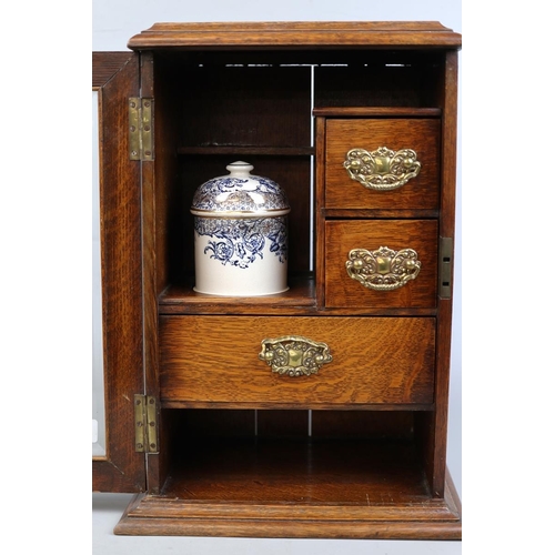 150 - Edwardian oak bevel glazed smokers cabinet with gilded, blue and white porcelain humidor and white m... 