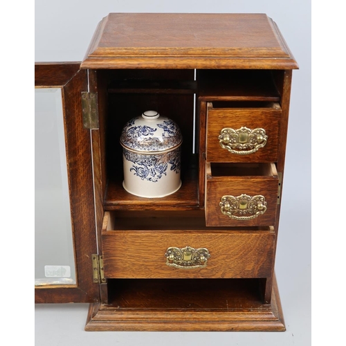 150 - Edwardian oak bevel glazed smokers cabinet with gilded, blue and white porcelain humidor and white m... 