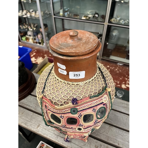 253 - Lidded terracotta pot with cane wrap together with a Jordanian woman's mask