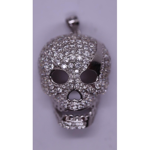 28 - Stone set silver pendent in the form of a skull