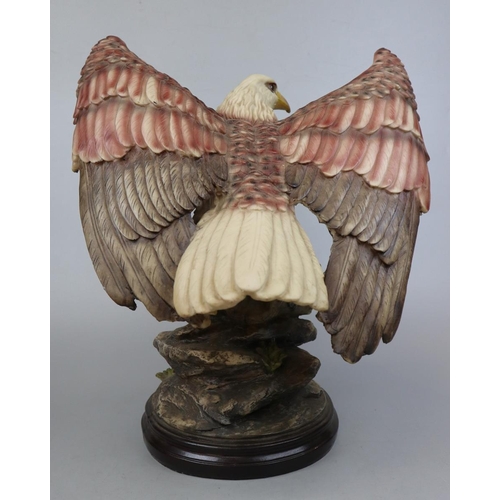 380 - Large Eagle figure on wooden plinth - Approx height 47cm