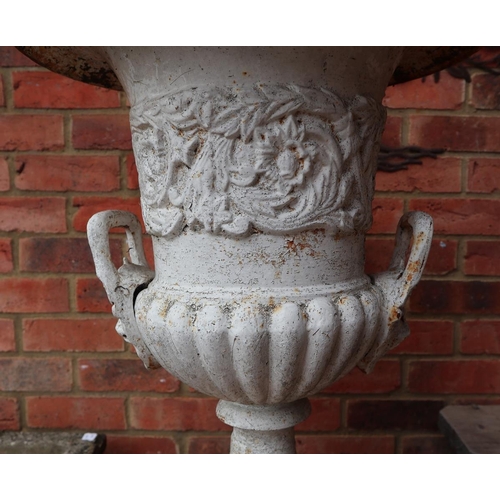 549 - Pair of cast iron urns togther with 2 stone plinths