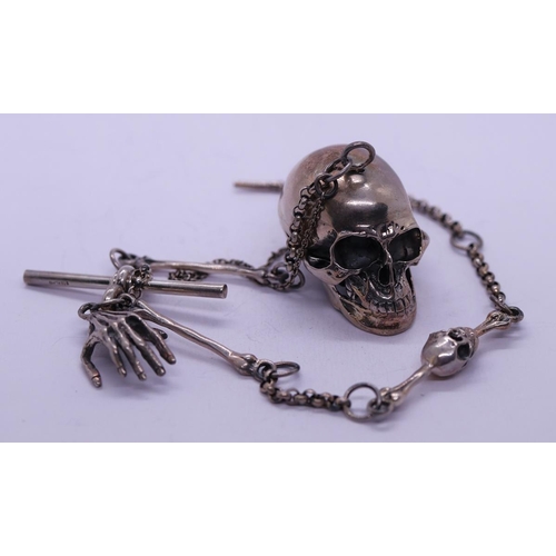 76 - Silver Albert chain in the form of a skull and hand together with a silver creeping skull ring