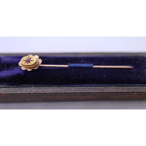 42 - 9ct gold stick pin set with a ruby