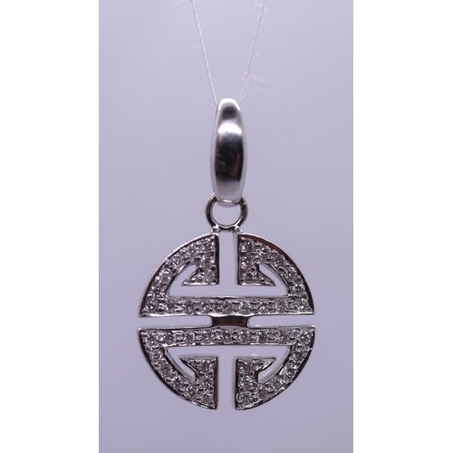 54 - 18ct white gold diamond Aztec style pendent