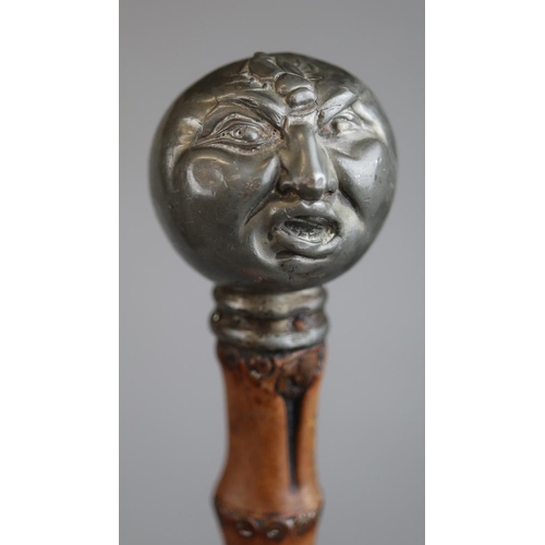 138 - Bamboo walking stick with pewter handle in the form of a Victorian grotesque man being stung by a be... 