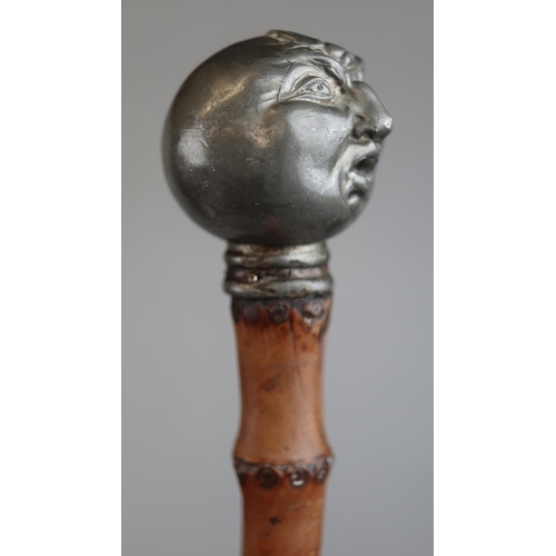 138 - Bamboo walking stick with pewter handle in the form of a Victorian grotesque man being stung by a be... 