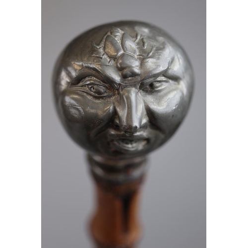 138 - Bamboo walking stick with pewter handle in the form of a Victorian grotesque man being stung by a be... 