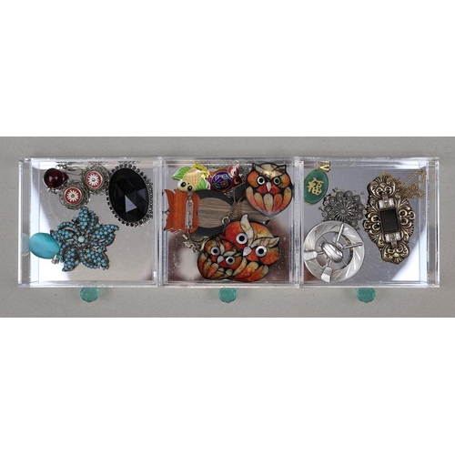 132 - Collection of costume jewellery in acrylic drawers to include silver