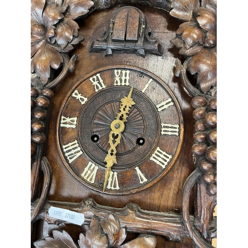 325 - Spring driven Cuckoo clock with carved vine decoration