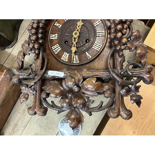 325 - Spring driven Cuckoo clock with carved vine decoration