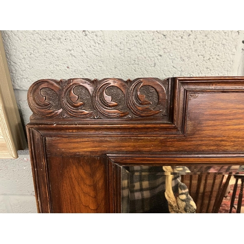 352 - Early 20thC carved oak framed bevelled glass mirror