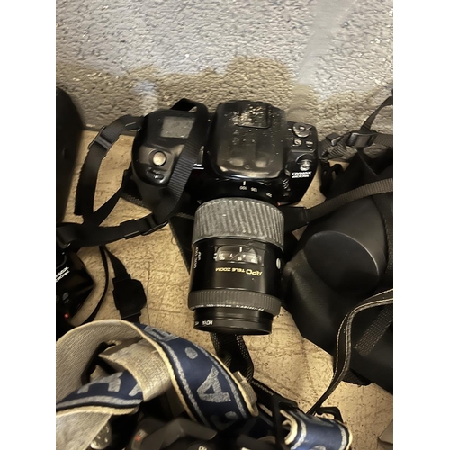 396 - Large collection of camera equipment to include binoculars