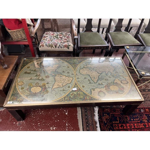 526 - Glass top coffee table depicting world map - Approx W: 133cm D: 69cm H: 37cm