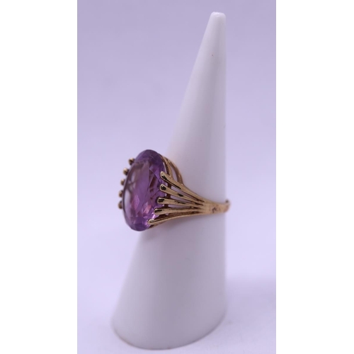 63 - 9ct gold ring set with a large amethyst - Size J