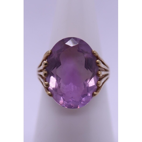 63 - 9ct gold ring set with a large amethyst - Size J