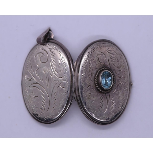 38 - Silver blue topaz set locket