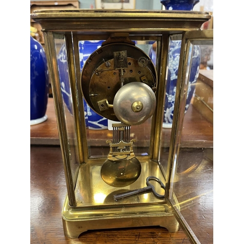 553 - Brass and glass mantle clock with pendulum and key