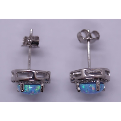 64 - Pair of silver opal set earrings