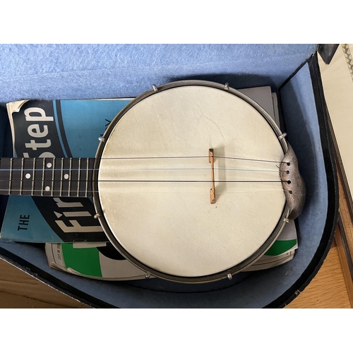 310 - Cased ukulele together with a child's guitar