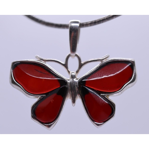 64 - Silver amber set butterfly pendent on silver chain