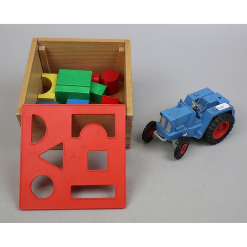 158 - Tri-ang 'Tugster' cast iron tractor together with a children's wooden block set