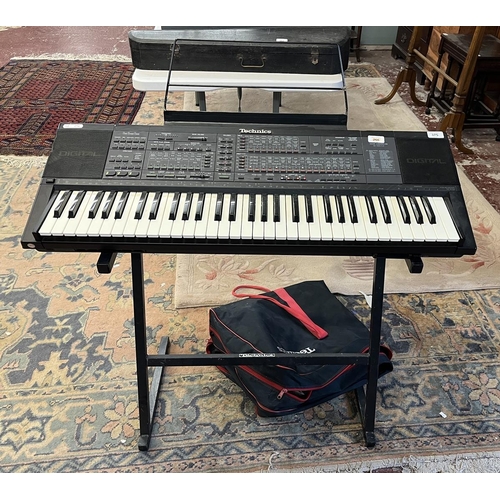 375 - Technics SX-K700 PMC electronic keyboard together with stand, foot pedal, carry case and book in goo... 