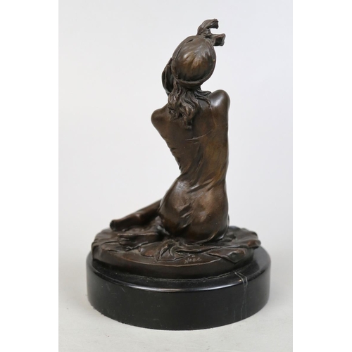 134 - 20thC bronze of a woman holding a phone marked 'noll' on marble stand - Approx H: 21cm