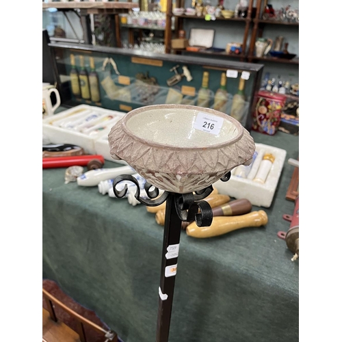 216 - Canterbury and large wrought iron candle stick