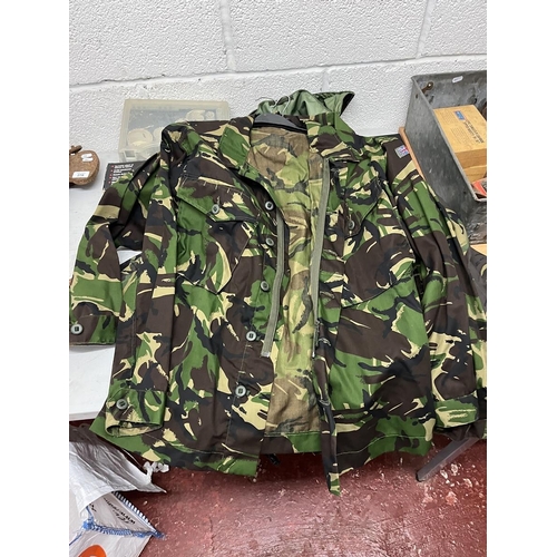 283 - Collection of waterproof and breathable camouflage jackets and 2x trousers together with rucksack