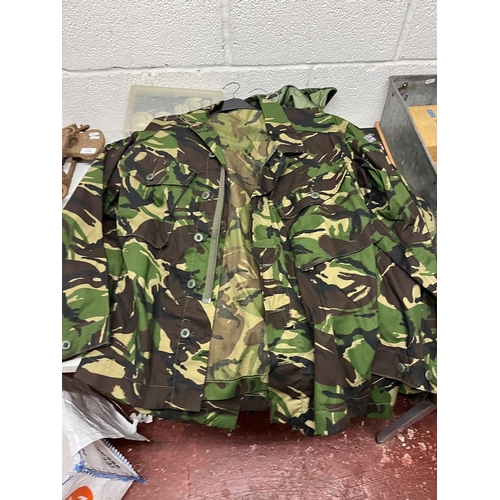 283 - Collection of waterproof and breathable camouflage jackets and 2x trousers together with rucksack