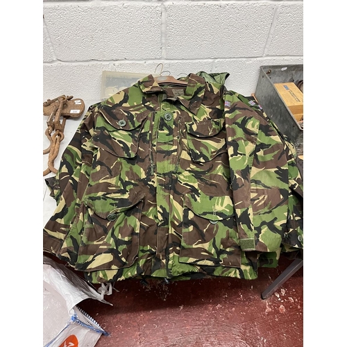 283 - Collection of waterproof and breathable camouflage jackets and 2x trousers together with rucksack