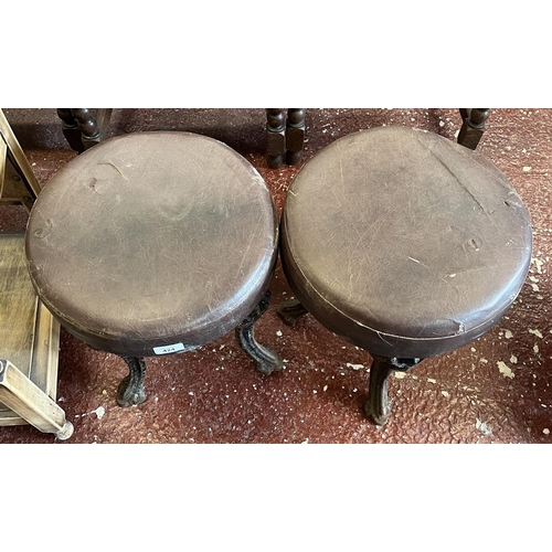 424 - Pair of antique cast-iron pub stools