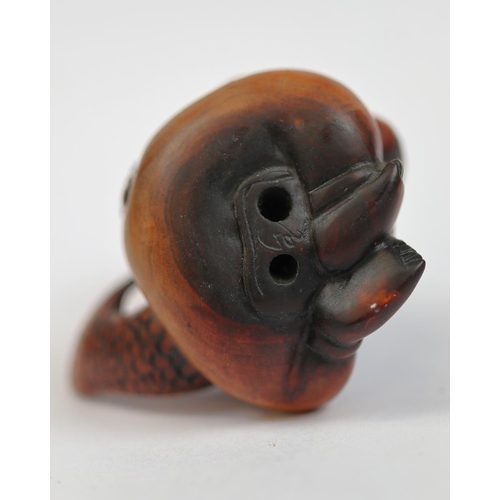 97 - Wooden Netsuke of boy holding fish - signed to base