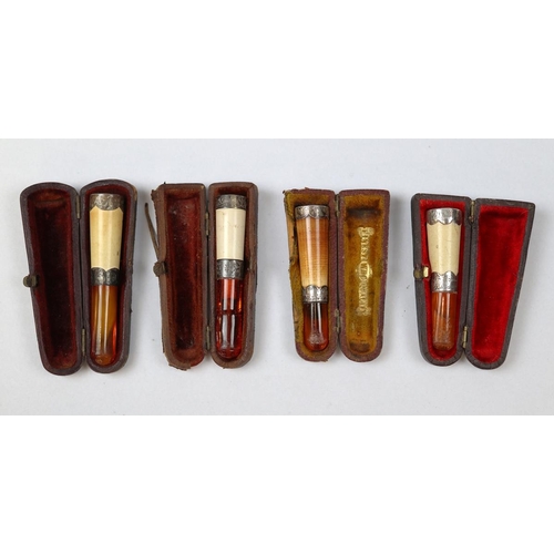 158 - 4 x Meerschaum and amber Cheroot holders with silver tips and collars, all cased.