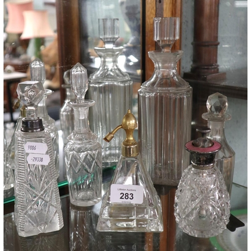 283 - Collection of perfume bottles to include a silver topped example