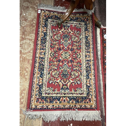 635 - Small red patterned rug - Approx size 108cm x 58cm