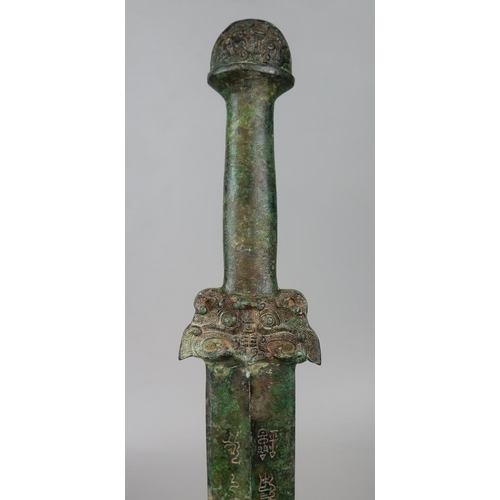 274 - Arcaic bronze Chinese sword with script to both sides of the blade. Taotie mask hilt possibly Shang ... 