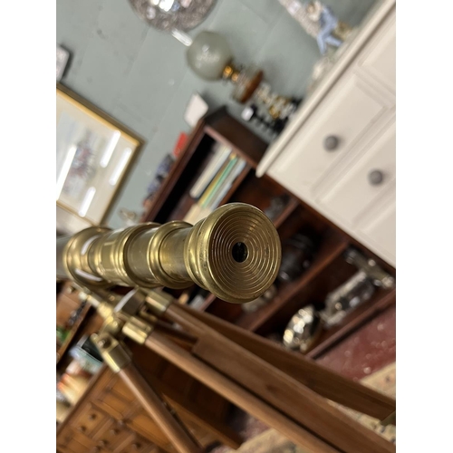 471 - 1900's style brass telescope on extending wooden tripod stand.