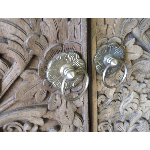 438 - Intricately carved pair of Eastern doors and doorframe - Approx size: Width of frame: 94cm H: 197cm