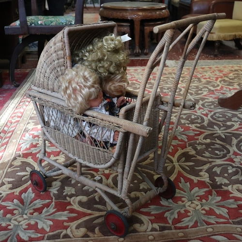 516 - Collection of dolls in vintage wicker pram