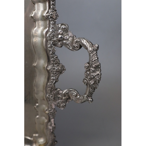 116 - Large mid 20c silver plated heavy tray 46cms x 35. Gadrooned edges and heavily decorated with two ha... 