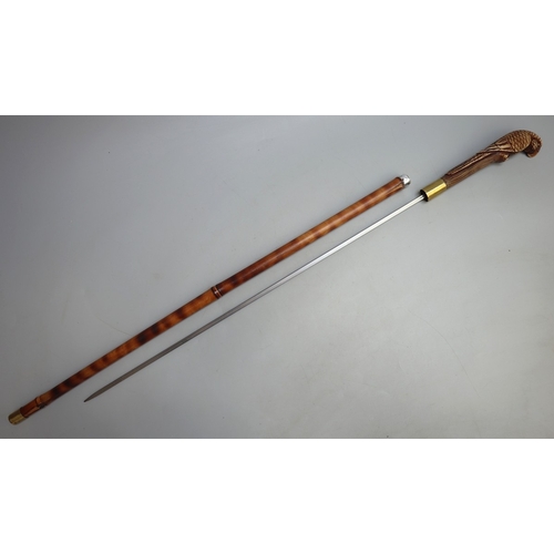 317 - Bamboo cane swordstick, with brass collar and ferrule and 'parrot' design handle
