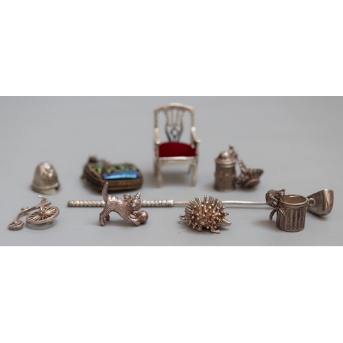13 - Collection of silverware to include napkin rings, small dolls furniture, charms and belly button bar... 
