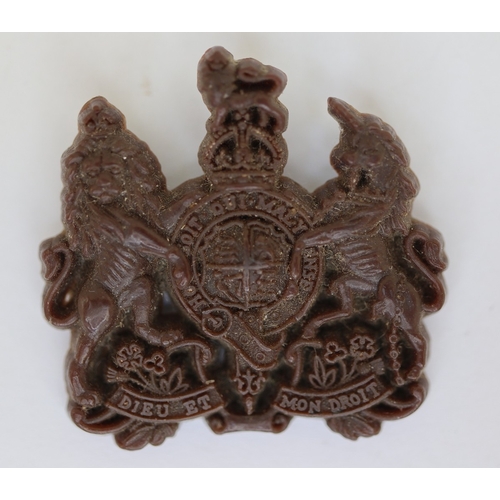 34 - Collection of military badges, gun pull through etc